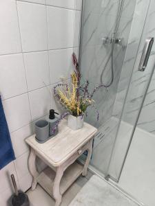 a bathroom with a wooden table with a shower at Orion Casais in Casais