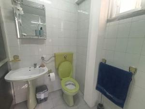 a bathroom with a green toilet and a sink at Orion Casais in Casais