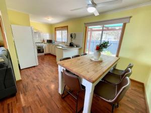 a kitchen and dining room with a wooden table and chairs at Blue Lagoon in American River