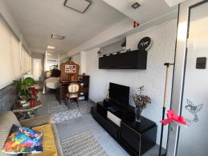 a living room with a couch and a tv at Orion Casais in Casais