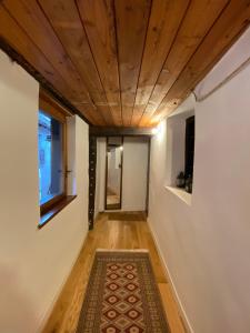 a hallway with a rug and a wooden ceiling at La Casetta in Bannio
