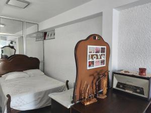 a bedroom with a bed and a dresser with a mirror at Orion Casais in Casais
