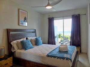 a bedroom with a bed with a view of the ocean at Amazing 2BR with private pool in Oyster Pond in Oyster Pond