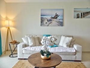 a living room with a couch and a table at Amazing 2BR with private pool in Oyster Pond in Oyster Pond +14 photos