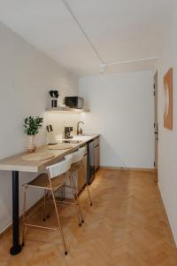 a kitchen with a table and chairs in a room at Pranik Living Wellness Coliving Laureles Medellin in Medellín