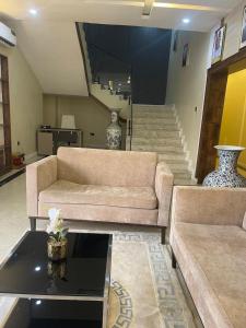 a living room with two couches and a coffee table at Eduardo Hotel in Dushekoro