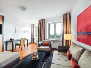 a living room with a couch and a table at Main Plaza Suite Tower in Frankfurt/Main