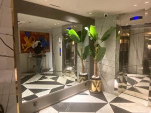a lobby with a mirror and a potted plant at TAJ HOTEL Executive Apartments - F7 Islamabad in Islamabad +153 photos