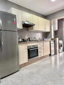 a kitchen with a stainless steel refrigerator and appliances at Luxury and serenity HARHOURA in Temara