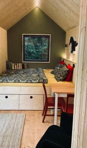 a bedroom with a bed and a table in a room at Tinyhouse v zahradě 