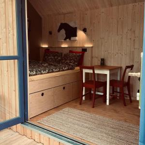 una habitación con una cama y una mesa con sillas en Tinyhouse v zahradě, 