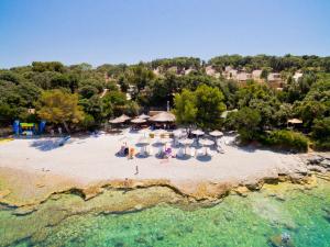 an aerial view of a beach with chairs and umbrellas at Brioni Sunny Camping by Valamar in Pula