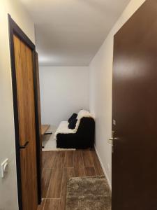 a room with a couch in the corner of a room at studio ski aux pieds avec parking couvert in Les Deux Alpes