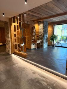 a large room with a stone wall and a table at Hotel Rio Bianco in Panchia