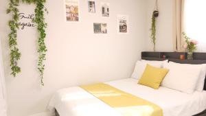 a bedroom with a bed with plants on the wall at Gongrim Stay in Seoul