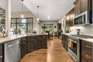 a large kitchen with wooden cabinets and stainless steel appliances at Winston's Luxurious Retreat in Coeur d'Alene