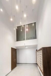 an empty room with a mirror and a large wall at Apartamenty MOOD HARMONY Garbary 40 in Poznań