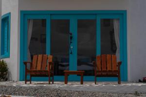 two chairs sitting in front of a building at Olymp Spa Boutique Hotel in Monte das Gameleiras