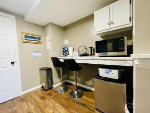 a kitchen with a counter with a microwave and a counter top at Cozy Small Room - Queen bed - Free Parking in Charlottetown in Charlottetown +15 photos