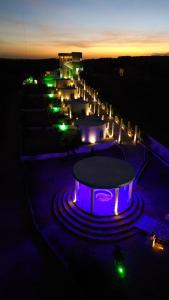 a group of buildings with lights at night at Olymp Spa Boutique Hotel in Monte das Gameleiras +2 photos