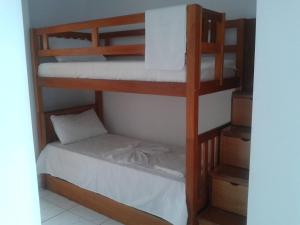a bunk bed in a room with a bunk bed in a room at Pousada Castelo do Gaúcho in Baía Formosa