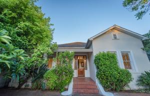 una casa bianca con un vialetto di mattoni rossi di Charming Historic Home in Central Stellenbosch a Stellenbosch