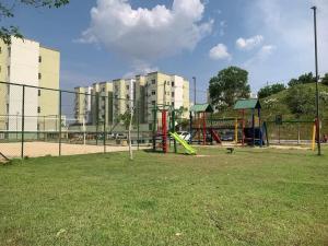 a park with a playground in front of buildings at Apt na Amazônia in Manaus