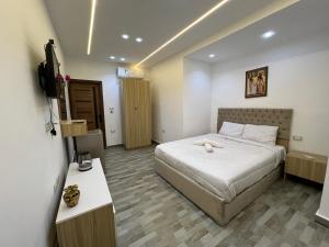 a bedroom with a bed and a television in a room at khufus pyramids view INN in Cairo