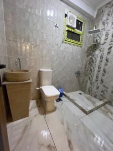 a bathroom with a toilet and a sink and a shower at Golden king pyramids view INN in Cairo +35 photos