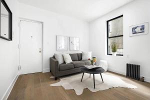 a living room with a couch and a table at Modern Upper West Side Private Room by Central Park in New York
