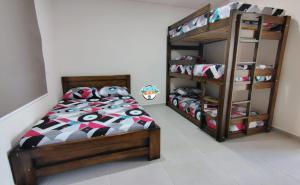 a bedroom with a bed and a bunk bed at Sun Beach in Puerto Colombia +38 photos