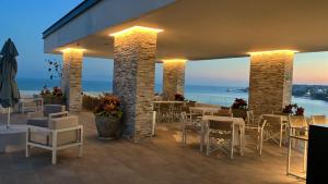a restaurant with tables and chairs and a view of the ocean at Casa Cielo V-Bucerias in Bucerías