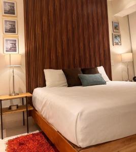 a bedroom with a large bed with a wooden headboard at Casa Cielo V-Bucerias in Bucerías