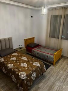 Ένα ή περισσότερα κρεβάτια σε δωμάτιο στο El Aouina al wahate