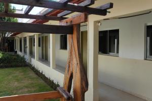 a wooden pergola on the side of a house at Lagos Hotel in Itajubá