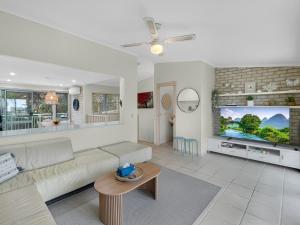 2-Bed Townhouse with Outdoor Area في Long Beach: غرفة معيشة مع أريكة وتلفزيون بشاشة مسطحة