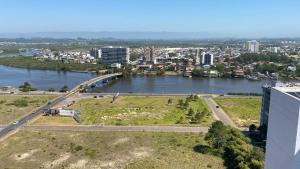 a bridge over a river next to a city at Apê da Paula in Torres