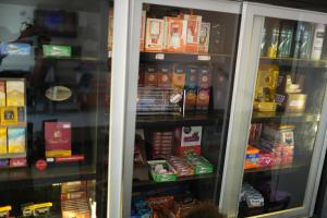 a refrigerator filled with lots of different types of food at Lagos Hotel in Itajubá
