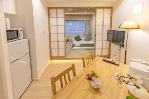 a small apartment with a dining table and a living room at New mansion 7 mins from Yoyogi stations in Tokyo