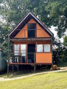 a small house with glass windows in a yard at Cabaña Sol in Calimita