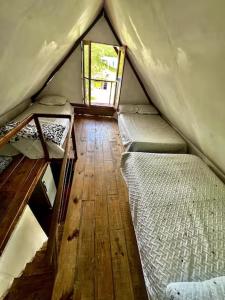 a room with two beds in a tent at Cabaña Sol in Calimita