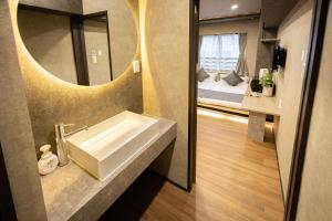 a bathroom with a sink and a mirror and a bed at New mansion 7 mins from Yoyogi stations in Tokyo +57 photos