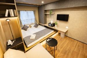 a small room with a bed and a desk at New mansion 7 mins from Yoyogi stations in Tokyo