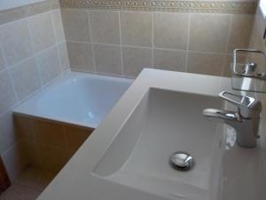 a white bath tub in a bathroom with a sink at Attic at 91 in Pinoso
