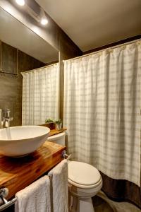 a bathroom with a sink and a toilet at Hoteles Pueblo de Tierra in San Pedro de Atacama