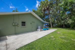 a green house with a playground in front of it at Crystal River Getaway in Crystal River +26 photos