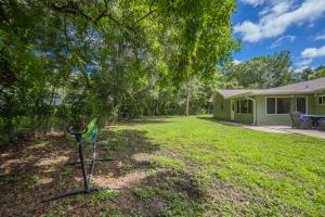 a house with a yard with a tree at Crystal River Getaway in Crystal River