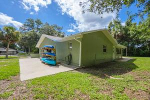 a small green house with a slide in the yard at Crystal River Getaway in Crystal River