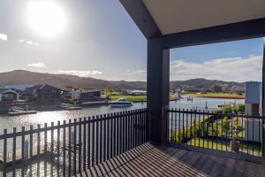 a view of a river from a house balcony at Luxury Beach Retreat - Mountain Views & Boat Jetty in Whitianga