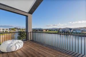 a balcony with a view of the ocean at Luxury Beach Retreat - Mountain Views & Boat Jetty in Whitianga